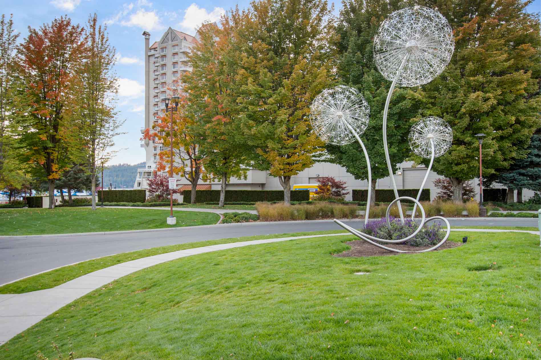 North Idaho park lawn with trees and public art
